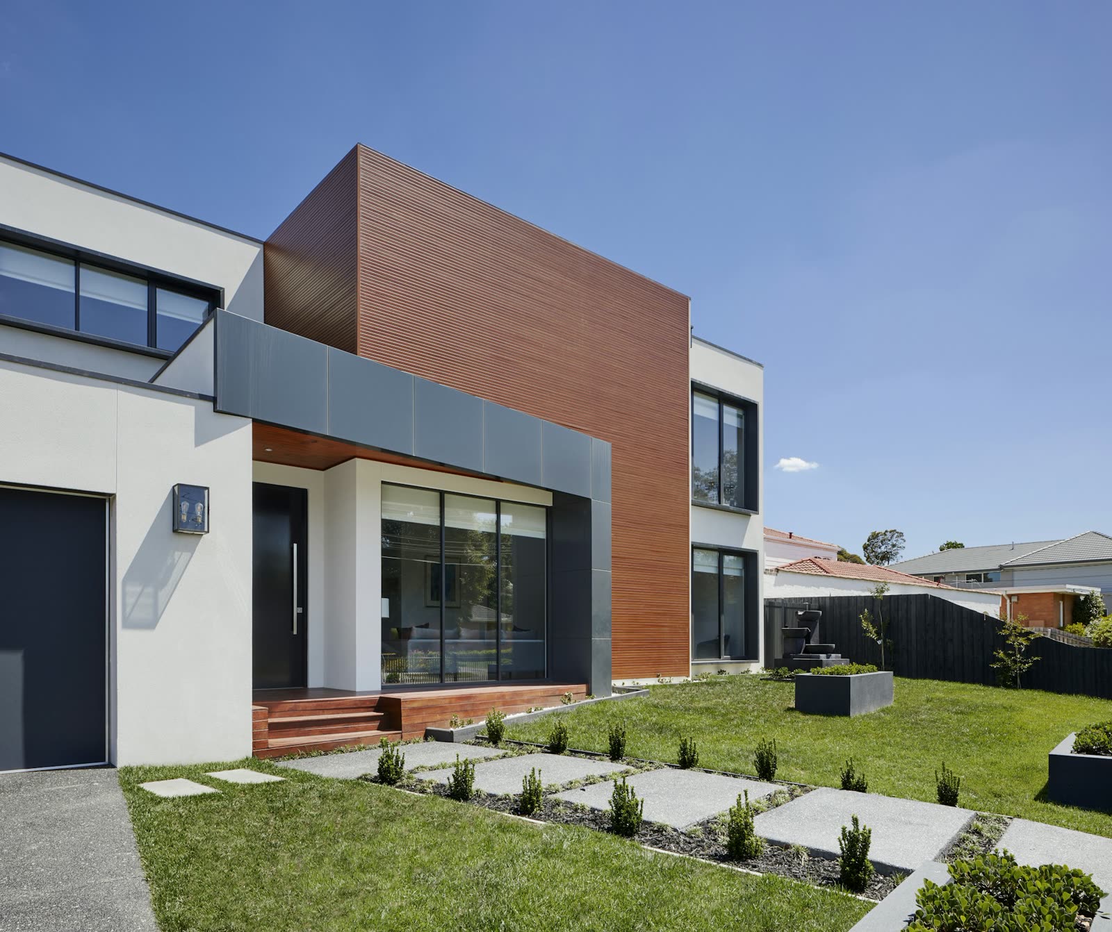 Photo: Finished house, full front elevation under a clear sky